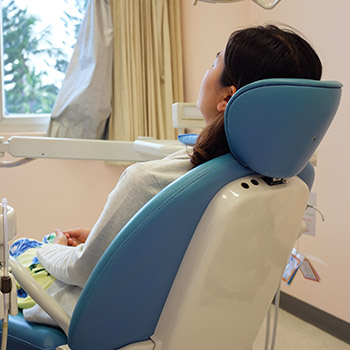 Relaxing patient in dental exam chair