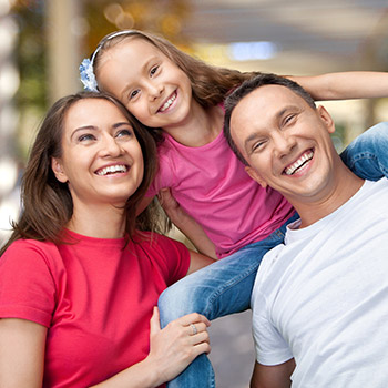 Mother father and daugther smiling