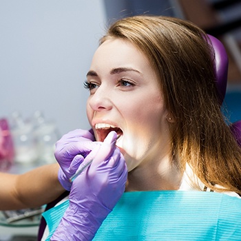 Portage patient displaying teeth with magnifying glass