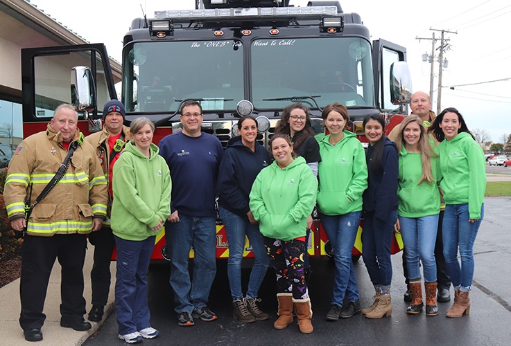 team in front of firetruck