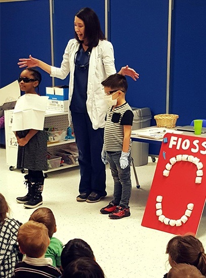 Dentist showing kids what to expect during dental appointment