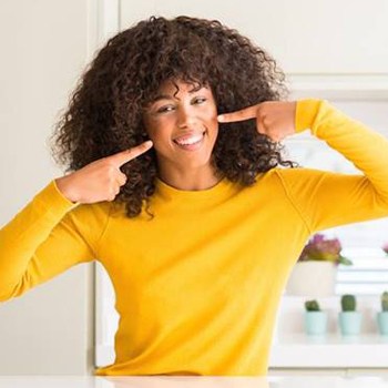 Woman pointing at healthy smile