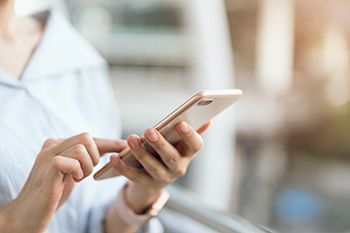 Closeup of patient looking at phone