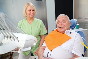 Older man consulting dentist on multiple tooth replacement in Portage.