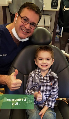 boy doing thumbs up with doctor