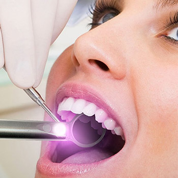 Woman receiving oral cancer screening