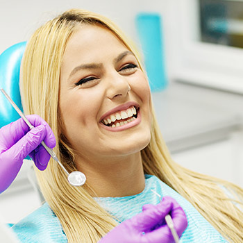 Laughing woman in dental chair