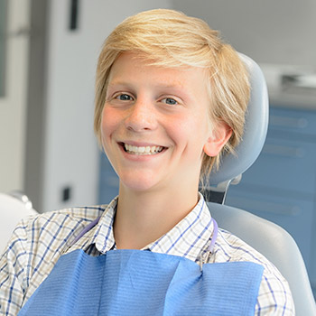 Young man in dental chair smiling