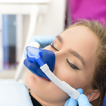 Woman with nitrous oxide nasal mask