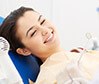 Smiling young woman in dental chair