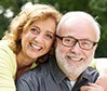 Smiling older man and woman outdoors