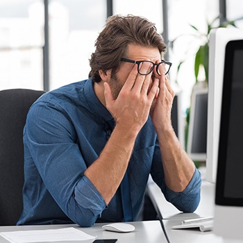 Tired frustrated man with head in hands