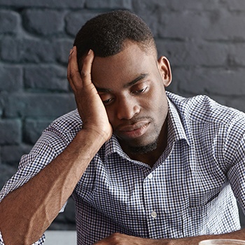 Frustrated man with head in hands