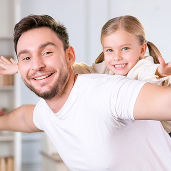 Father and daughter playing a game together