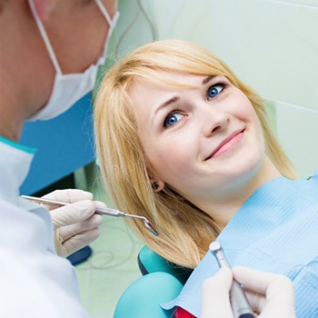 A woman smiling in the dentist chair