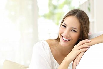 A woman smiling on a couch