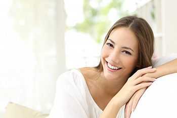 A woman smiling on a couch