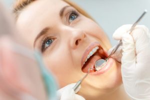 a woman having her teeth checked at the dentist’s office