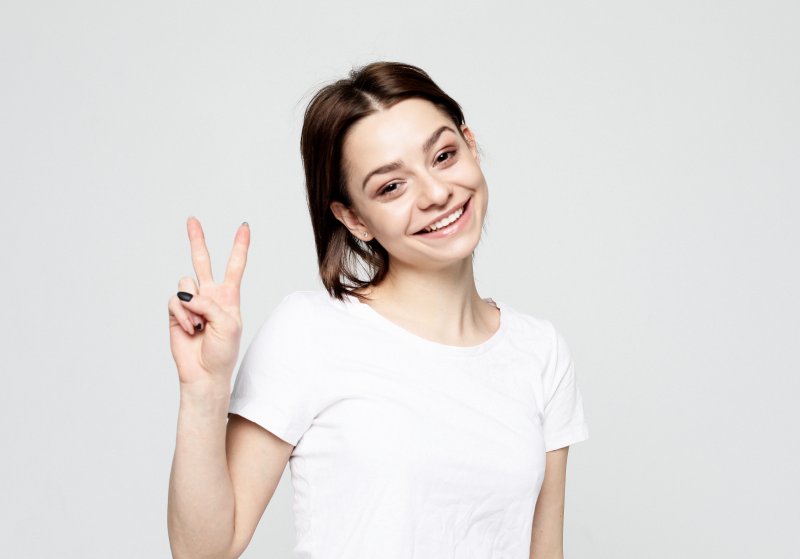 Woman using a peace sign to say hello