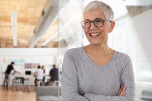 older woman smiling with dental implants in Portage