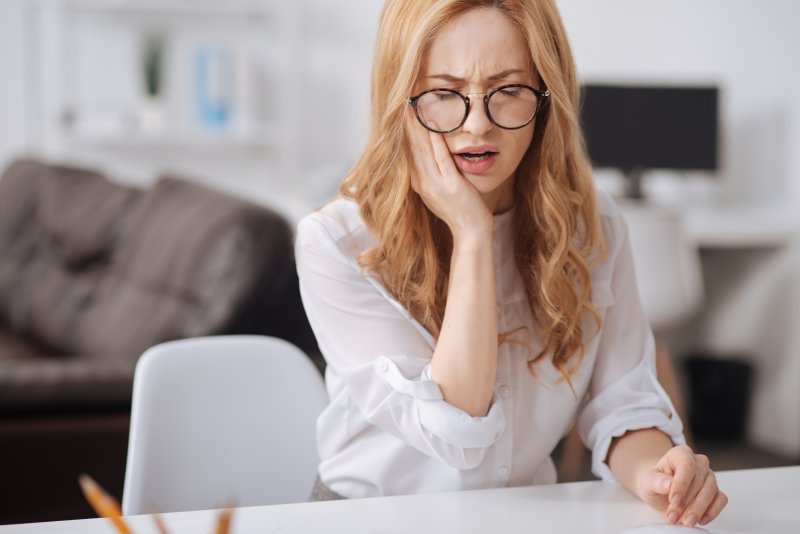 Woman experiencing a dental emergency