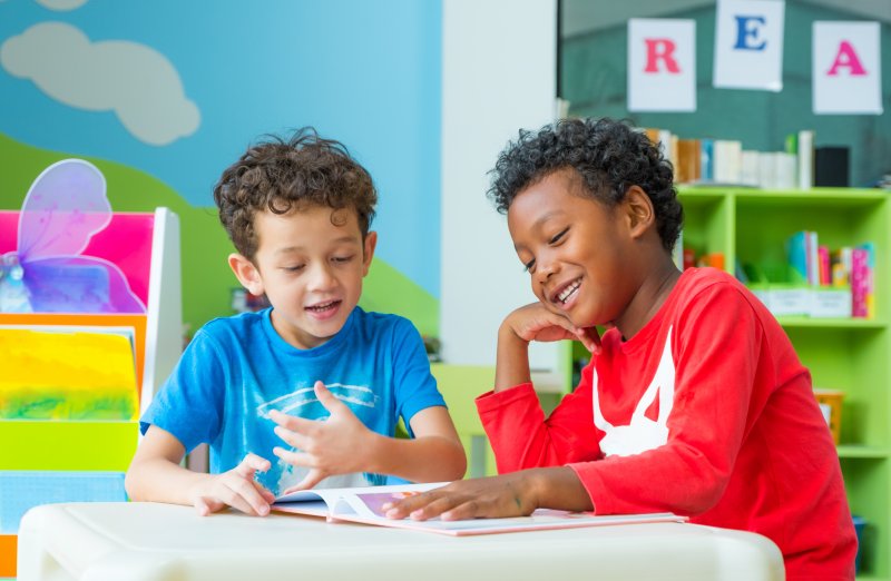 two young boys working together at school