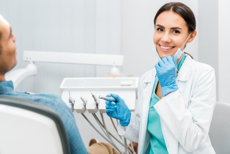 smiling female dentist performing dental checkup in Portage