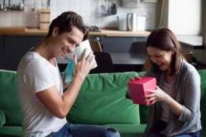 happy couple exchanging Valentine’s Day gifts