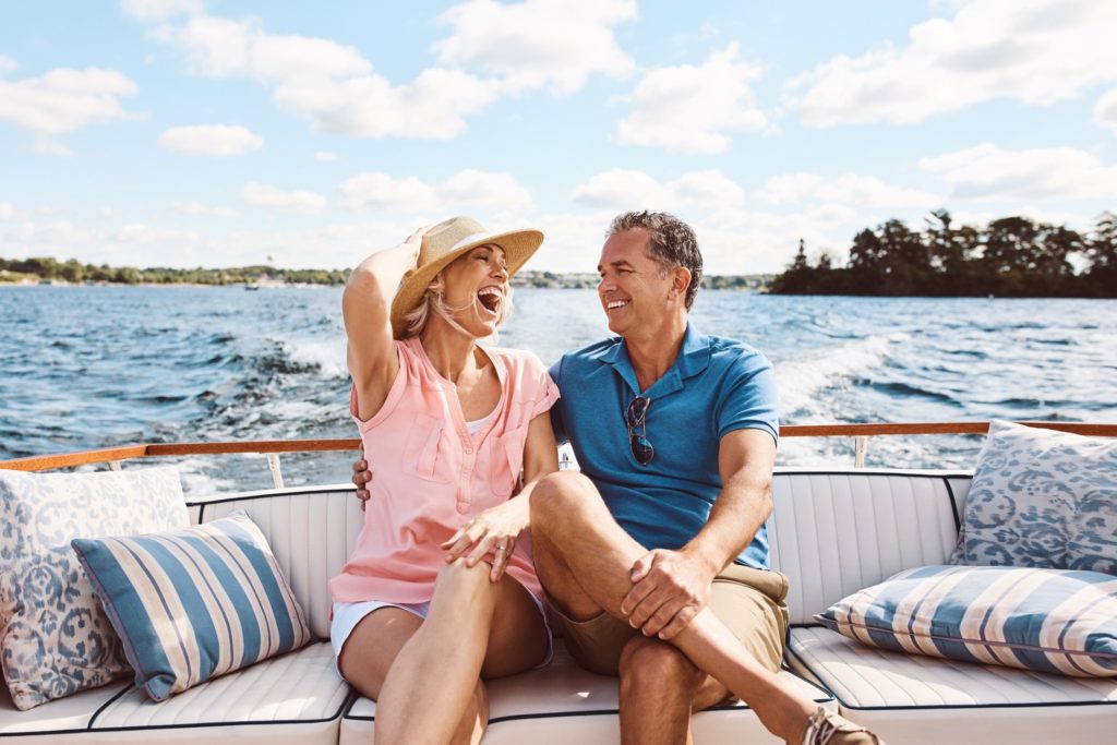 Couple laughing while enjoying an afternoon on the boat