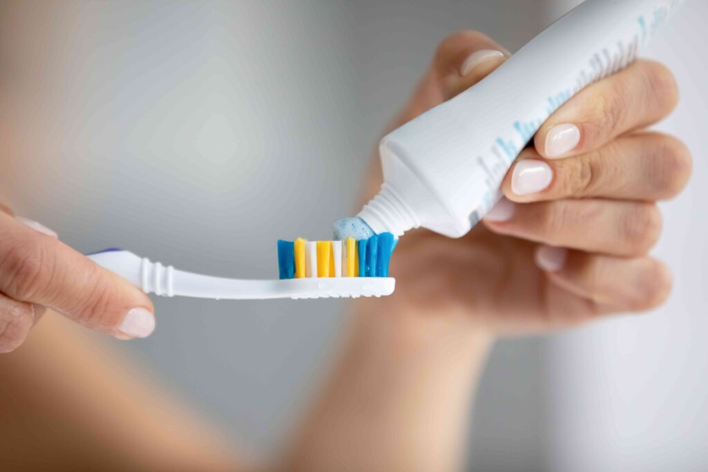 Woman applying toothpaste 